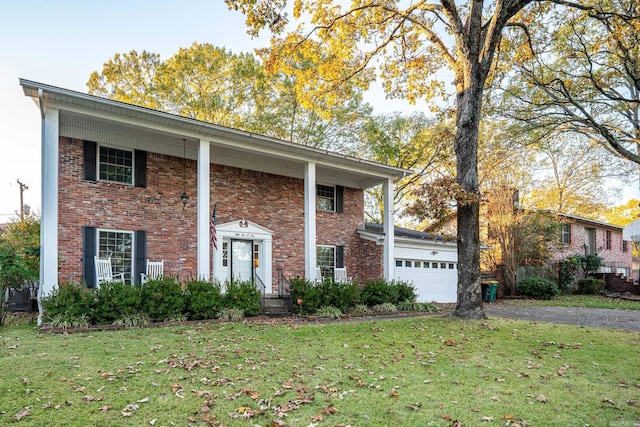 view of front facade with a front yard and a garage