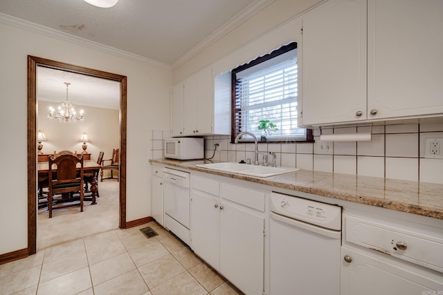 kitchen with tasteful backsplash, sink, white cabinets, and white appliances