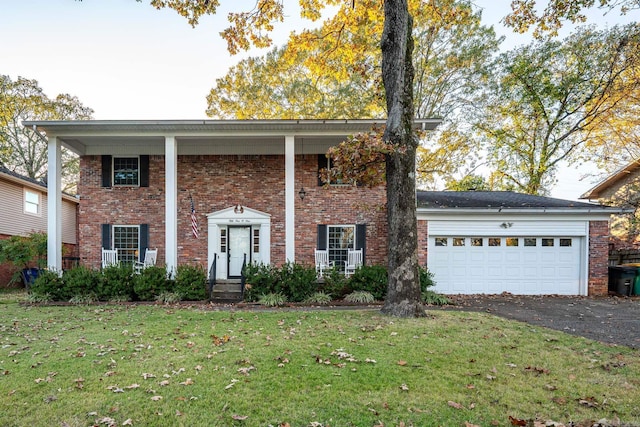 view of front of property featuring a garage and a front lawn