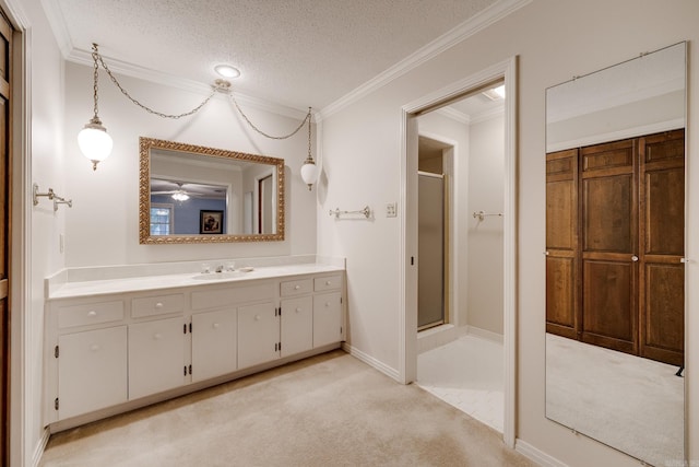 bathroom with an enclosed shower, ornamental molding, and a textured ceiling