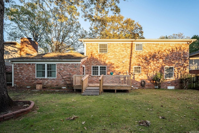 rear view of property with a yard and a wooden deck