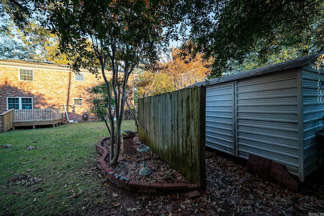 view of yard featuring a shed and a deck