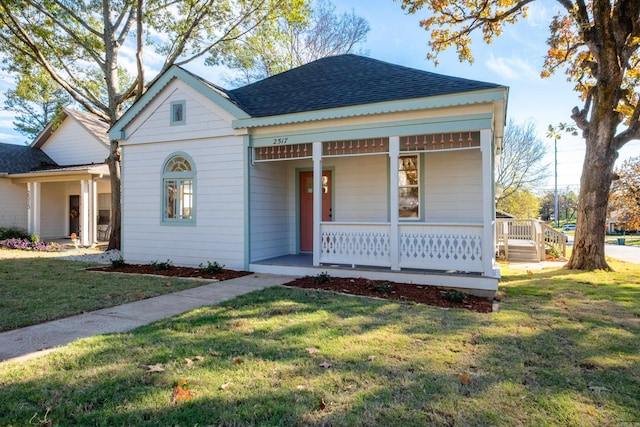 view of front of house with a front yard and a porch