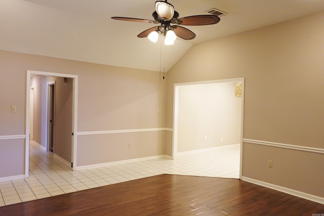 unfurnished room with ceiling fan, light hardwood / wood-style floors, and lofted ceiling