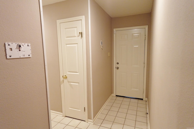 doorway featuring light tile patterned flooring