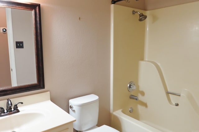 full bathroom featuring bathtub / shower combination, vanity, and toilet