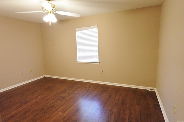 spare room featuring dark hardwood / wood-style flooring and ceiling fan