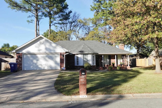 ranch-style home featuring a front lawn, covered porch, and a garage