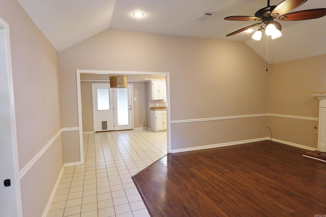 spare room featuring ceiling fan, vaulted ceiling, and light hardwood / wood-style flooring