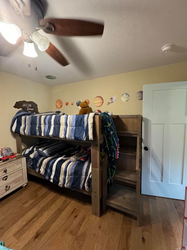 bedroom with hardwood / wood-style floors and ceiling fan