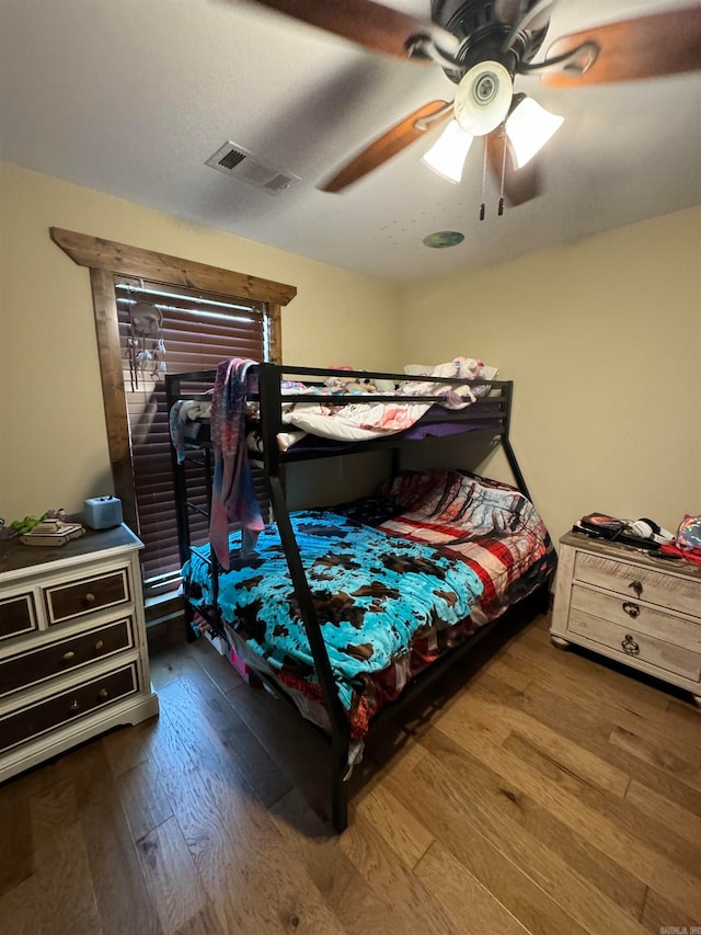 bedroom with hardwood / wood-style floors and ceiling fan