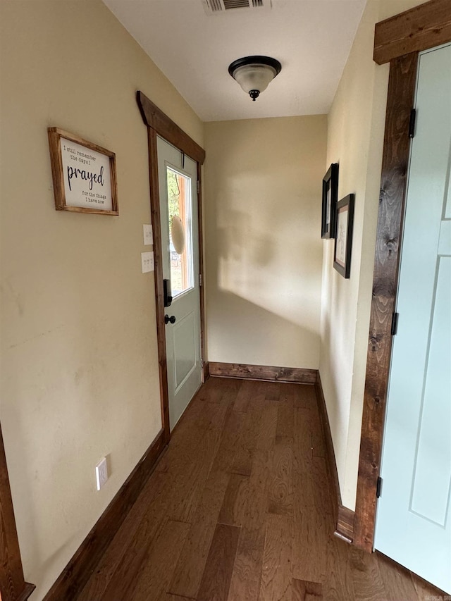 hallway with dark hardwood / wood-style flooring