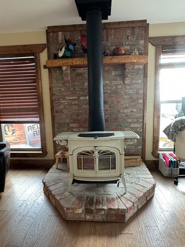 details with wood-type flooring and a wood stove