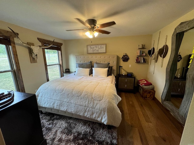 bedroom with ceiling fan and wood-type flooring