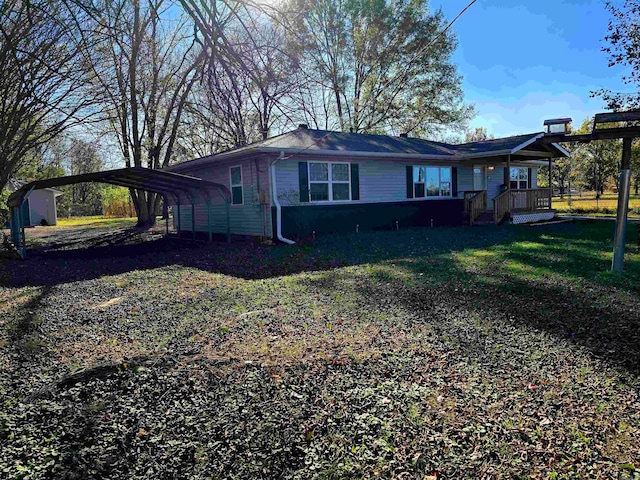 view of property exterior with a carport and a yard