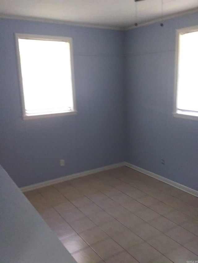 unfurnished room featuring plenty of natural light and light tile patterned flooring