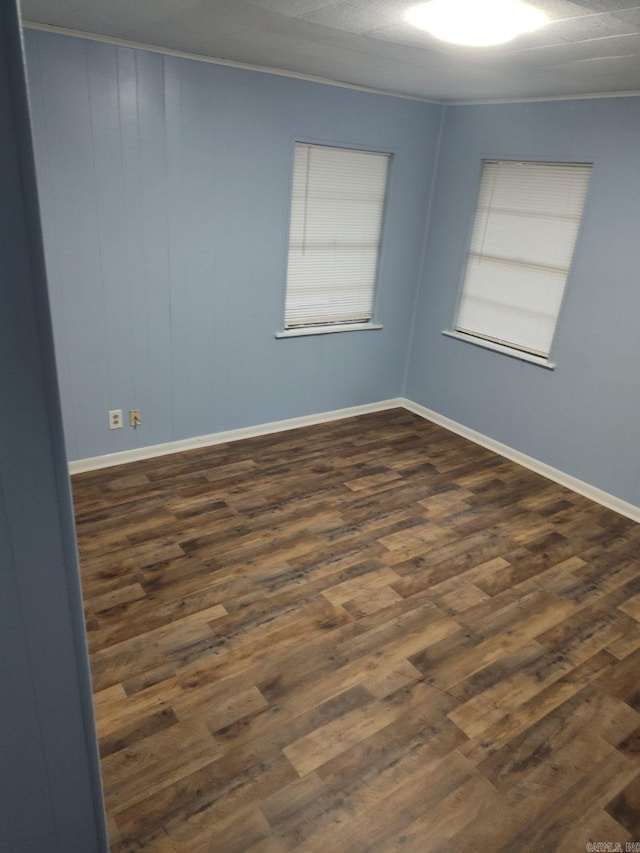 unfurnished room featuring crown molding and dark hardwood / wood-style flooring