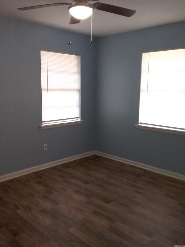 unfurnished room with dark hardwood / wood-style flooring