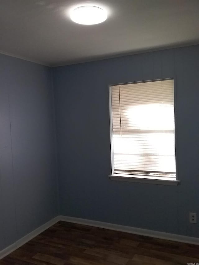 empty room with dark hardwood / wood-style floors