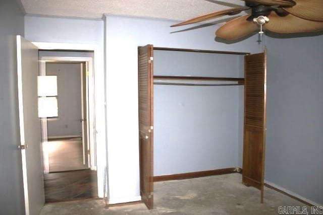 unfurnished bedroom featuring ceiling fan, concrete floors, a textured ceiling, and a closet