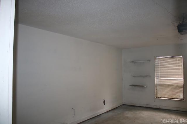 spare room featuring a textured ceiling