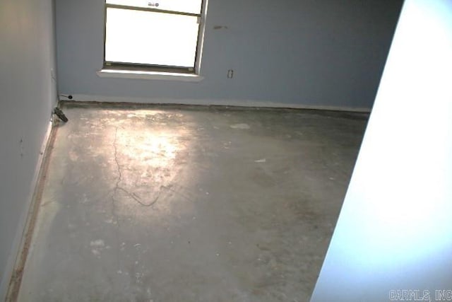 unfurnished room featuring concrete floors