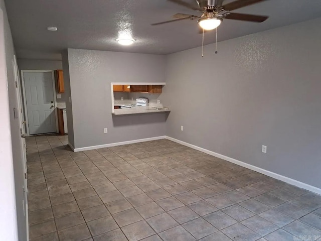 spare room with tile patterned floors and ceiling fan