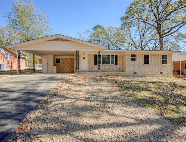 ranch-style home with a carport and central air condition unit