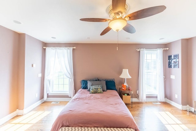 bedroom with ceiling fan and light hardwood / wood-style floors