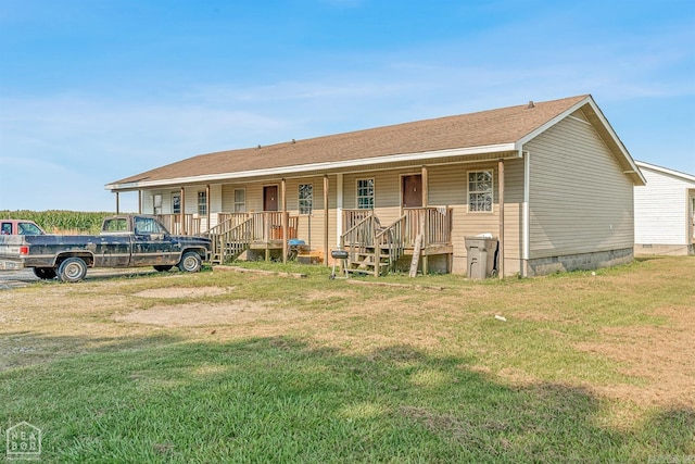 view of front of home featuring covered porch and a front yard