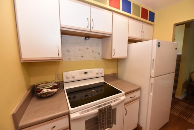 kitchen featuring white cabinets and white appliances