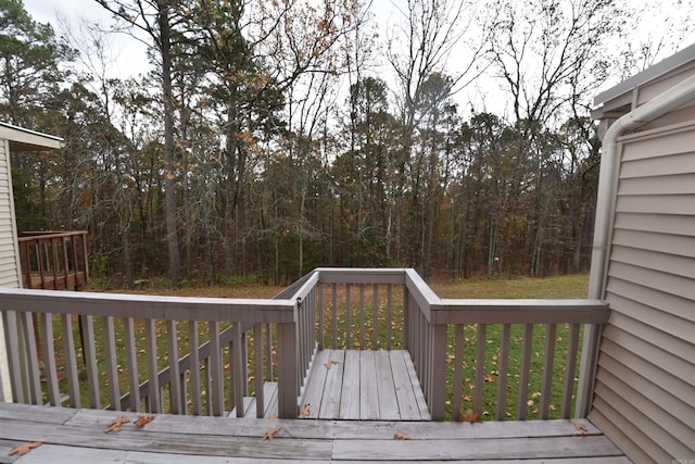 wooden deck featuring a yard