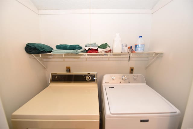 laundry area with washing machine and clothes dryer