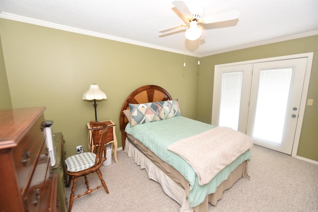 carpeted bedroom featuring ceiling fan and ornamental molding