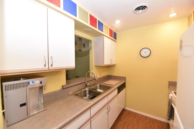 kitchen featuring white cabinets, dishwasher, light hardwood / wood-style floors, and sink