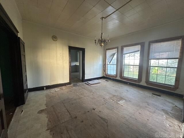 unfurnished dining area featuring a notable chandelier