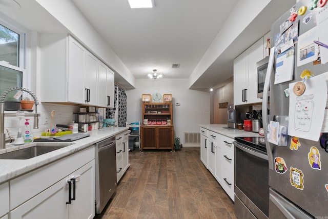 kitchen featuring white cabinets, sink, dark hardwood / wood-style flooring, and stainless steel appliances