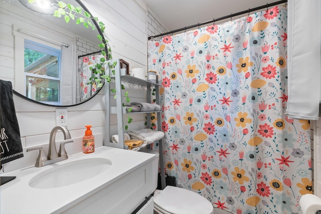 bathroom with a shower with shower curtain, vanity, toilet, and wooden walls