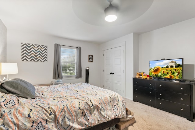 bedroom with carpet, ceiling fan, and a closet