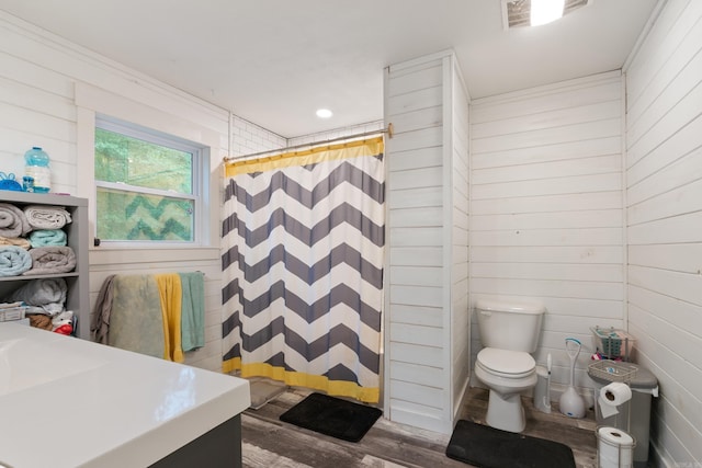 bathroom featuring a shower with shower curtain, vanity, hardwood / wood-style flooring, and toilet