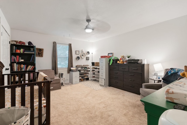 bedroom featuring ceiling fan and light carpet