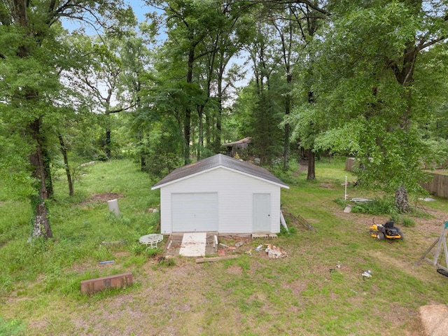 view of outbuilding featuring a garage and a lawn