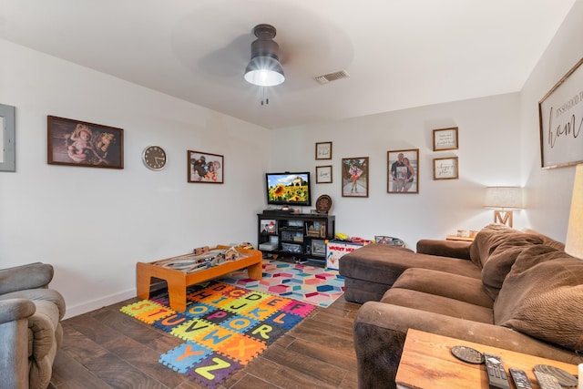 living room featuring dark hardwood / wood-style floors and ceiling fan