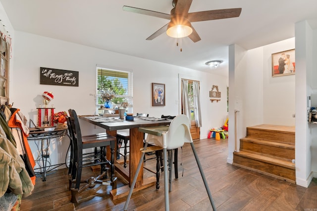 dining space featuring ceiling fan and dark hardwood / wood-style flooring