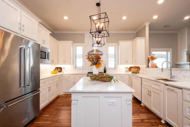 kitchen with sink, a center island, dark hardwood / wood-style flooring, white cabinets, and appliances with stainless steel finishes