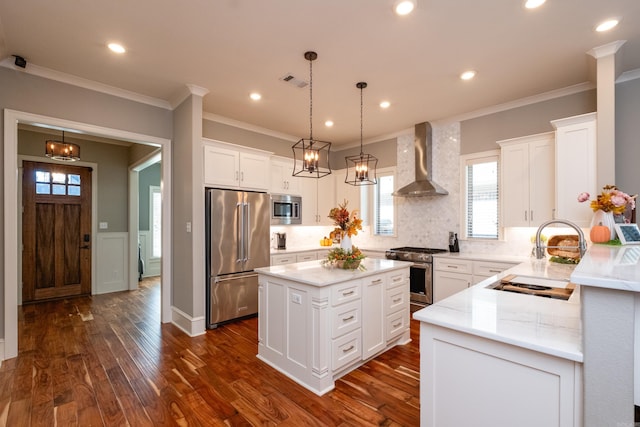 kitchen featuring light stone countertops, a center island, wall chimney exhaust hood, dark wood-type flooring, and high quality appliances