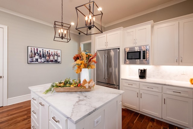 kitchen featuring white cabinets, stainless steel appliances, dark hardwood / wood-style floors, and ornamental molding