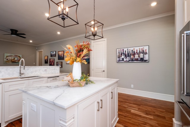 kitchen with a kitchen island, dark hardwood / wood-style flooring, white cabinetry, and sink