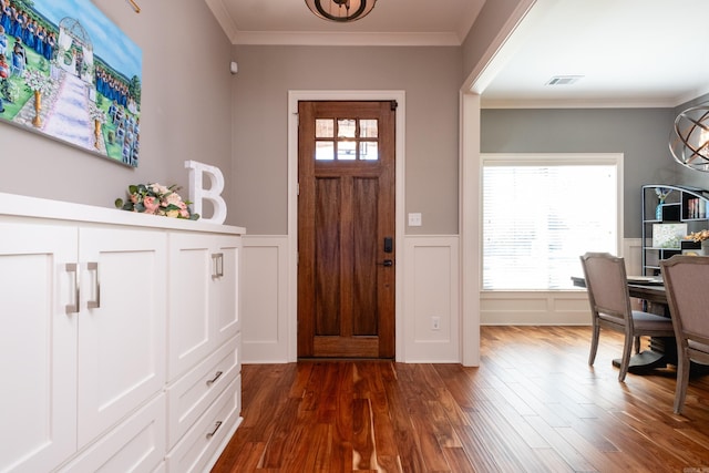 entryway with dark hardwood / wood-style floors, plenty of natural light, and crown molding