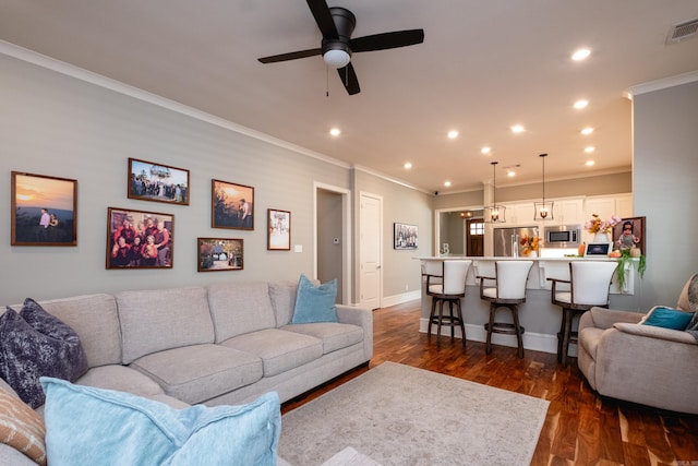 living room featuring ceiling fan, crown molding, and dark hardwood / wood-style floors